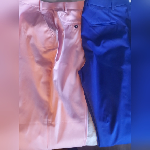 A pair of chinos that are a pale pink and royal blue in color. - Picture 2 of 2